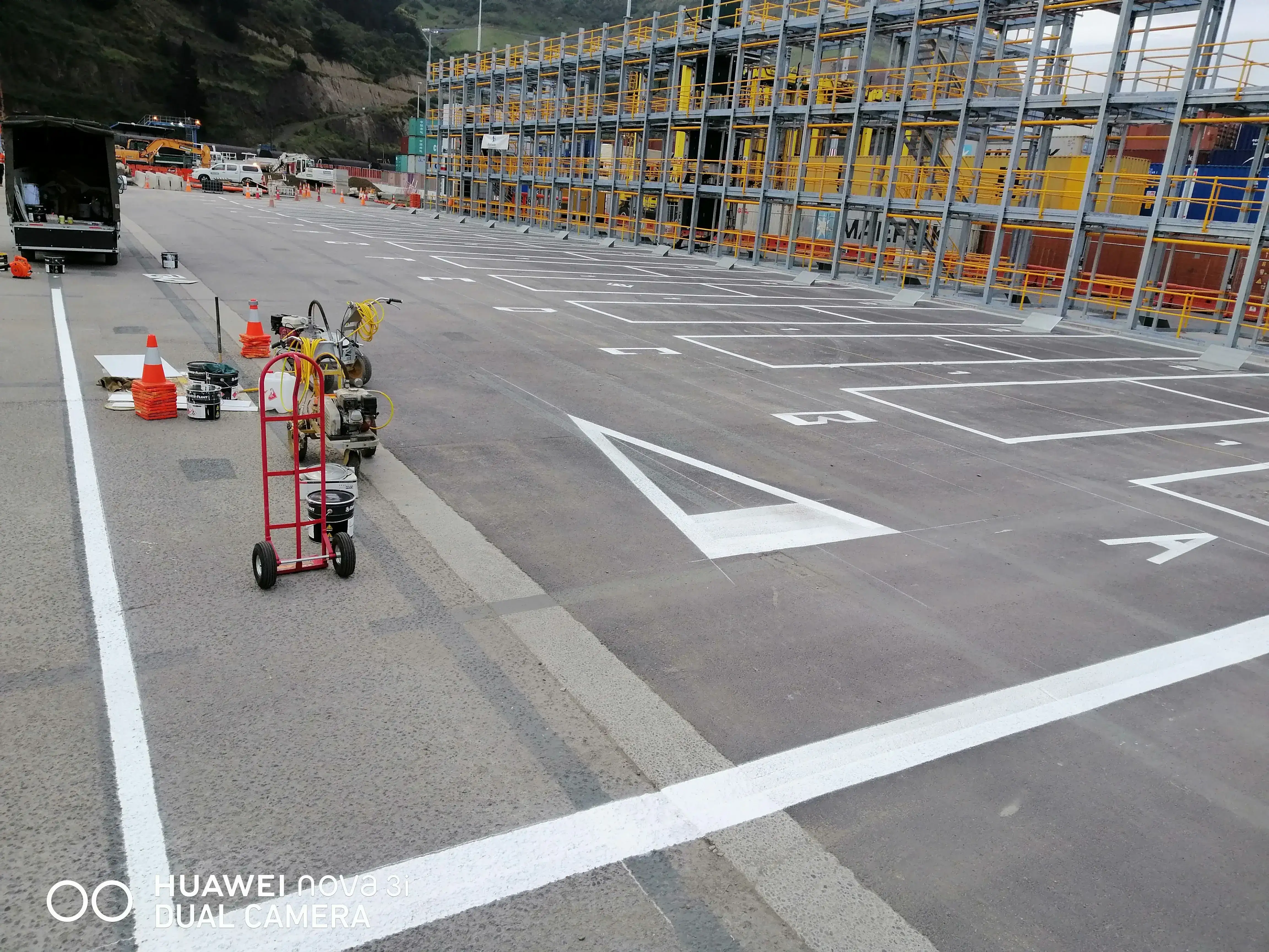 Stencilled bay numbers and letters with safety lines completed at a logistics hub.
