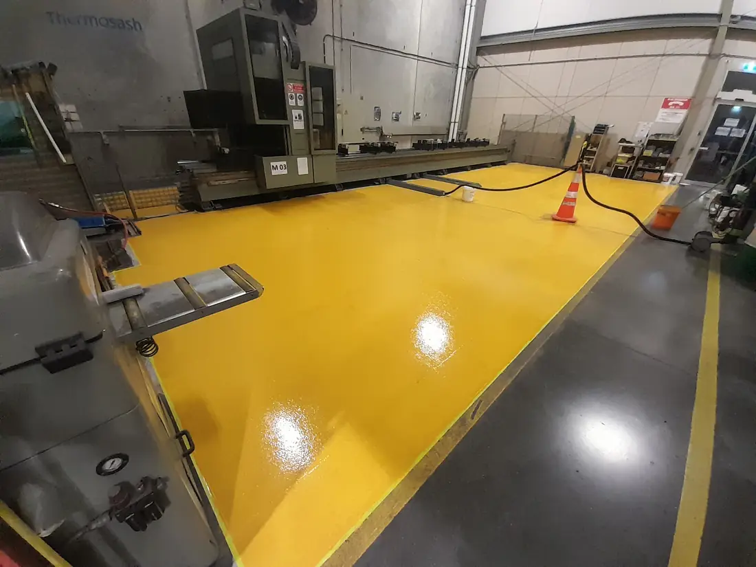 Completed yellow epoxy floor application at a Hornby industrial site