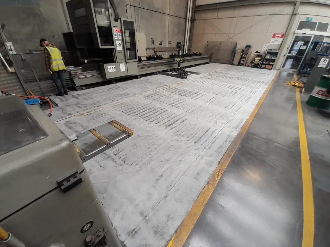 Concrete grinding preparation before an epoxy floor application at a Hornby industrial site