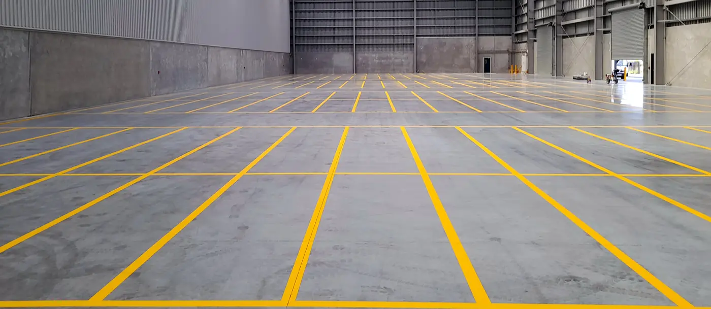 Yellow pallet-position lines marked across the floor of an Islington warehouse transition facility