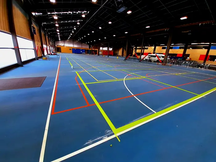 Indoor sports hall with fresh multi-colour court line marking