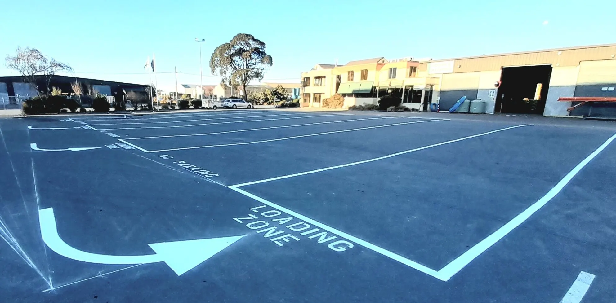 Loading zone and parking markings on freshly sealed carpark