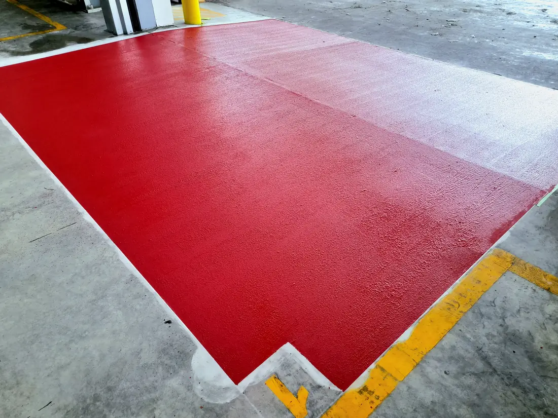Finished red non-slip coating at a forklift roller-door entrance in Izone, Rolleston