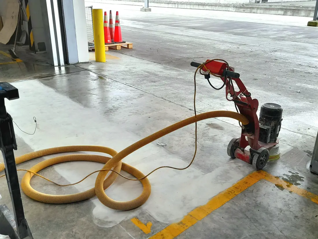 Mechanical floor preparation at a forklift roller-door entrance for an Izone transport company