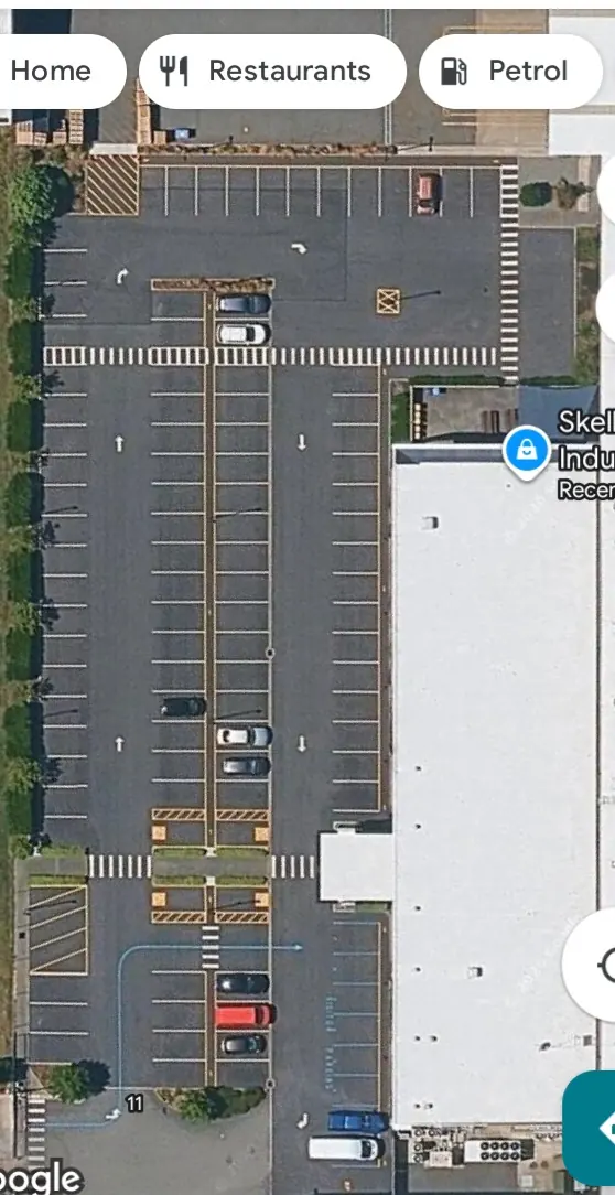 Aerial view of marked parking bays, pedestrian crossings and traffic arrows at a Wigram factory car park